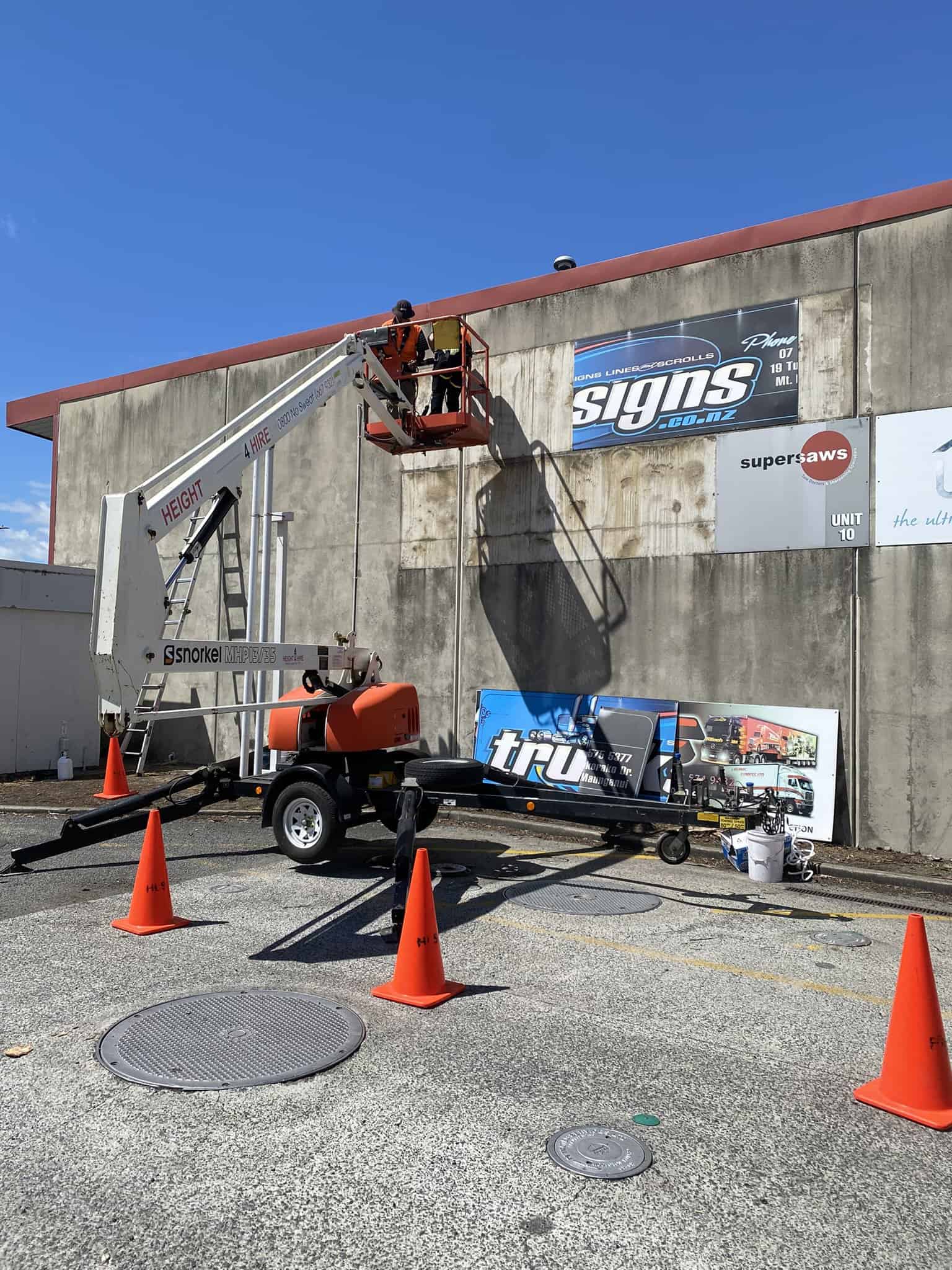 Cleaning the side of a building from a cherry picker lift