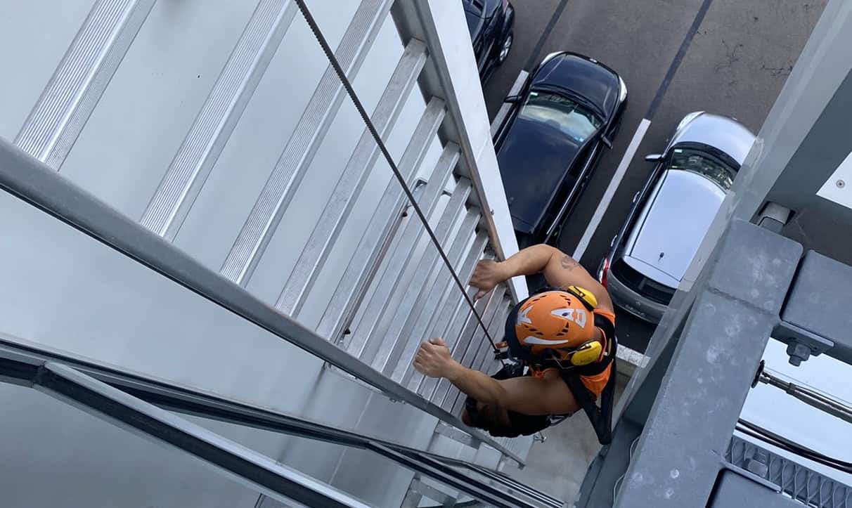 Worker accessing a roof via a ladder