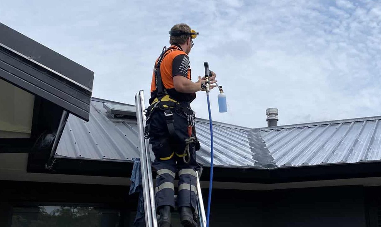 Water blasting and cleaning a roof by High Level Solutions